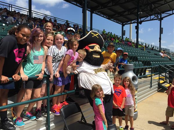 happy students pose with mascot at ballpark
